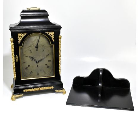 JAMES WOOD OF LONDON; a fine George III ebonised bracket clock, the swing brass handle above arched silvered dial inscribed '