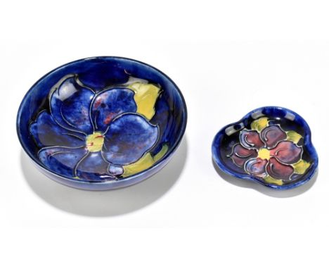 MOORCROFT; a small blue ground bowl decorated in the 'Clematis' pattern, diameter 11.5cm and a trefoil shaped dish, length 7c