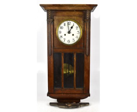 A 1940s oak wall clock with Arabic numerals to the circular dial.