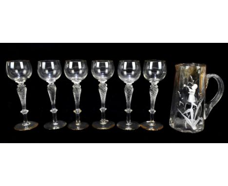 IN THE STYLE OF MARY GREGORY; a white enamel painted jug with reeded handle, height 19cm, and a set of six hock glasses with 