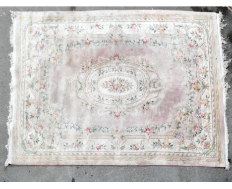A Chinese carpet, 480cm x 308cm, with another Chinese rug and two further rugs 150cm x 70cm and 160cm x 78cm (4).