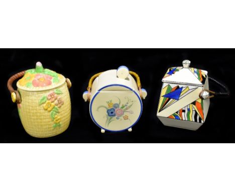 CLARICE CLIFF; a Wilkinson Pottery floral biscuit barrel with rattan handle, printed marks, a Art Deco biscuit barrel, printe