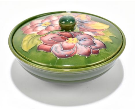 MOORCROFT; a green ground powder bowl and cover decorated in the 'Arum Lily' pattern, impressed marks, diameter 16.5cm.Additi