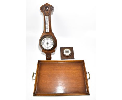 A 1920s oak aneroid barometer, length 59cm, together with a smaller aneroid barometer and an oak twin handled serving tray (3