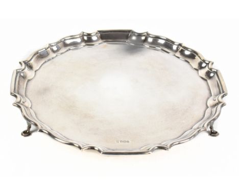 FENTON BROS LTD; a George V hallmarked silver salver with cast scalloped edge, raised on three pad feet, Sheffield 1931, diam