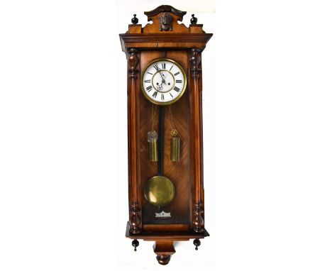 A walnut Vienna regulator, the enamel Roman numeral dial with subsidiary seconds, with eight day movement striking on a gong 