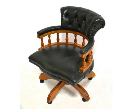 A reproduction swivel office desk chair with button padded top rail.