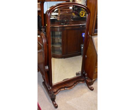 A reproduction mahogany cheval mirror, the central mirror of arched form with bevelled mirror plate, height 150cm,