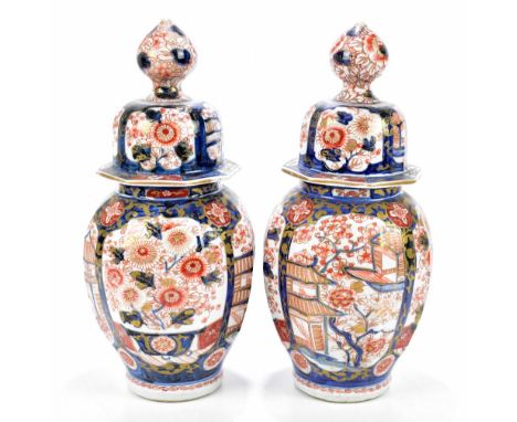 A pair of late 19th century Japanese rounded octagonal Imari vases and covers with gilt heightening throughout, unmarked, hei