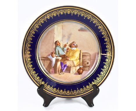 SEVRES; a cabinet plate with gilt border on a dark blue ground and with central panel, signed Max, depicting two figures seat