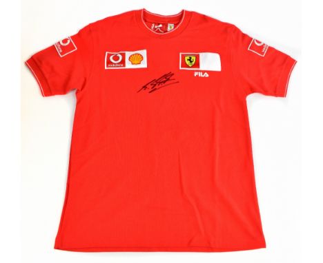 MICHAEL SCHUMACHER; a Ferrari F1 shirt, signed to the front, size M.Additional InformationCreasing and light general, no cert