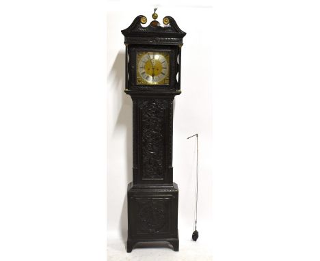 An 18th century eight day longcase clock, the brass dial with applied pierced mask heads and scrolling detail, with silvered 