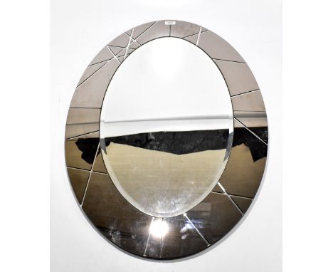 A decorative contemporary oval wall mirror.
