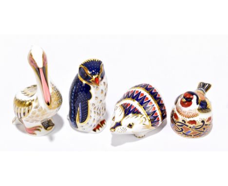 ROYAL CROWN DERBY; four paperweights, 'White Pelican' (event piece), 'Rock Hopper Penguin', 'Hedgehog' and 'Nesting Gold Finc