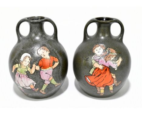 AMPHORA; a pair of twin handled vases each decorated with a pair of children dancing, marks to base, height 21cm.Additional I