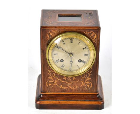A 19th century rosewood cased mantel clock with inlaid decoration, the circular silvered dial with engine turned decoration, 
