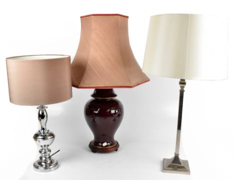 Three modern table lamps to include a red ground ceramic lamp with pink shade, tallest 46cm not including shade.Additional In