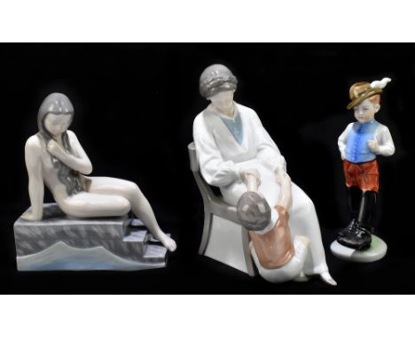 HEREND; a figure of a boy wearing a trilby, height 21cm, together with two Bing &amp; Grondahl figures including a nude maide