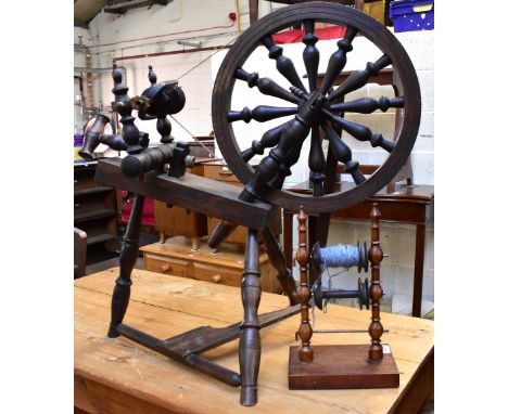A decorative spinning wheel and a bobbin (2).