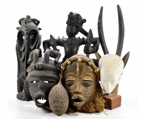 A small group of tribal art including African masks, also an Eastern darkwood carving, etc.PROVENANCE: from the Brian Morley 