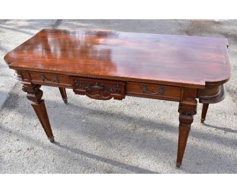 An Adam style mahogany crossbanded service table with single frieze drawer raised on square section tapering legs to brass ca