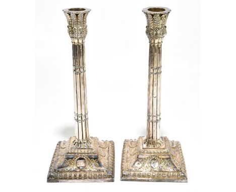A pair of early 19th century white metal loaded candlesticks, probably Dutch with leaf moulded integral sconces above fluted 