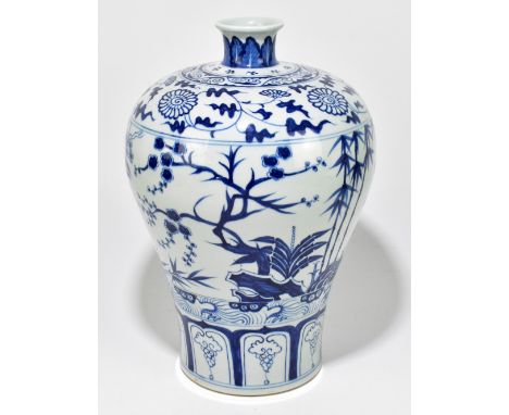 A modern Chinese Kangxi-style vase, decorated in underglaze blue with flowers and rock work, drilled to the underside of the 