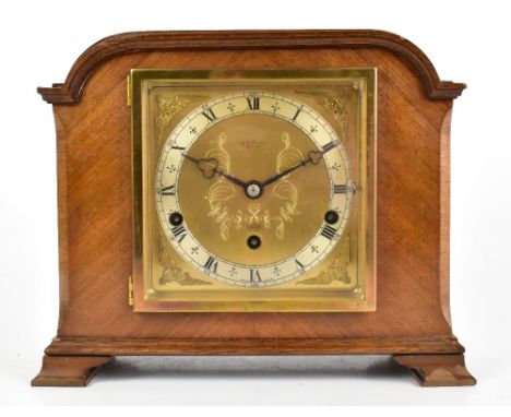 ELLIOT; a 1950s walnut cased chiming mantel clock, with gilt dial , with applied silvered chapter ring, raised on bracket fee