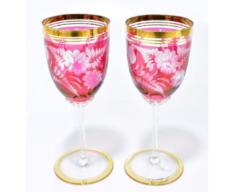 A pair of decorative Bohemian wine glasses each with etched floral detail and gilt rims, height 18.5cm (2). Additional Inform