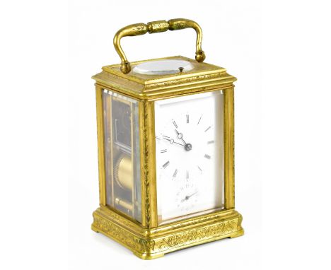 A late 19th century French engraved brass eight day carriage clock, the enamel dial with Roman numerals and Arab subsidiary s