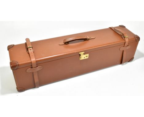 A good tan leather shotgun case originally for a pair of Merkel guns, with plum felt lined interior, height 21cm, width 83cm,