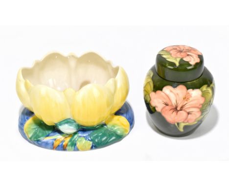 MOORCROFT; a ginger jar and cover decorated in the 'Hibiscus' pattern, height 16cm, together with a Clarice Cliff Water Lily 