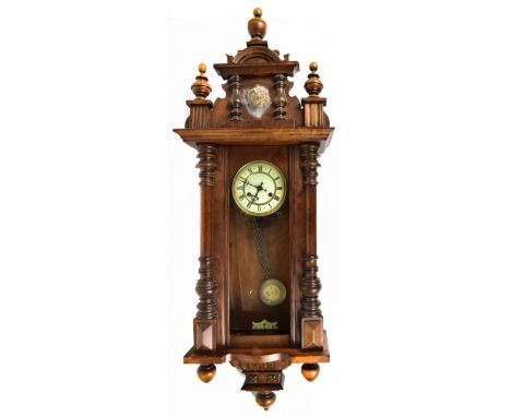 A late 19th century beech wood Vienna type wall clock, with applied lion head surmount to the finial, height 111cm (af).Addit