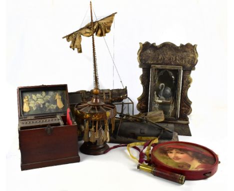 A quantity of curios created Tim Chitty incorporating Victorian elements including a model boat, cannon in a case, tambourine