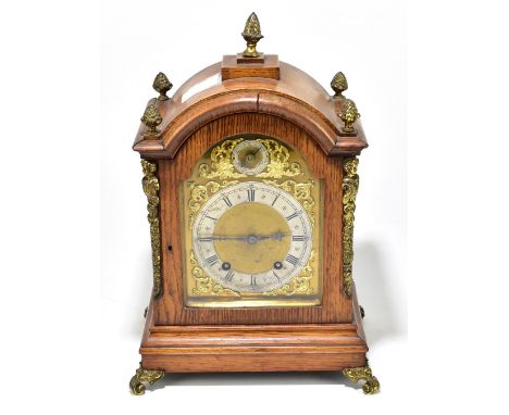 WINTERHALDER &amp; HOFMEIER; an early 20th century oak cased quarter striking mantel clock, the brass dial with applied silve