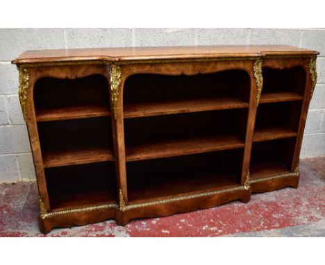 A good mid Victorian walnut and ormolu mounted open bookcase of breakfront form, the moulded top above three banks of adjusta