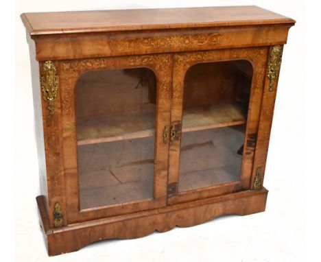 A Victorian inlaid walnut pier cabinet, the two glazed doors enclosing single fixed shelf, with ormolu mounts to the sides, r