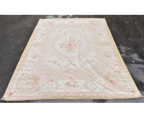 An Aubusson carpet with floral scroll decoration on a cream ground, width 270cm.