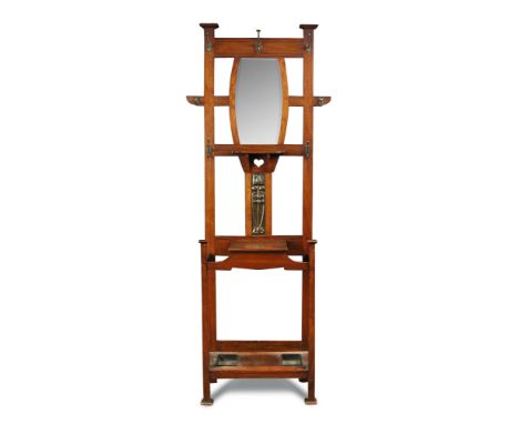 An Arts & Crafts walnut hall stand, the back with mirror and hook arrangement above an enamelled copper panel and pierced hea