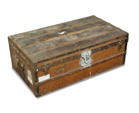 An early 20th century Louis Vuitton cabin trunk, the faded monogrammed body with timber bracing and carrying handles to each 