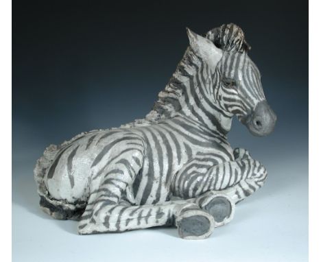 § Nick Mackman (British, 20th Century), Zebra, raku fired ceramic, modelled lying down 30 x 40cm (12 x 16in)  