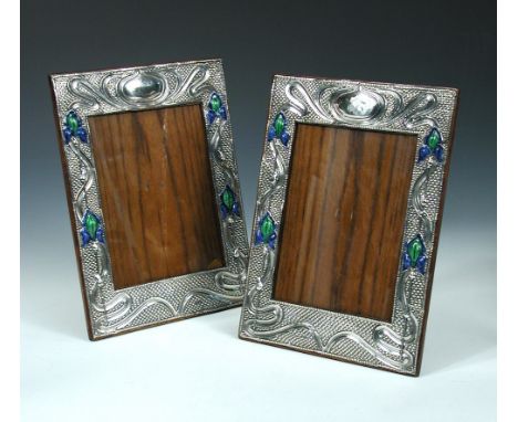 A matched pair of Art Nouveau easel-back silver and enamel photograph frames, by Joseph and Richard Griffin, Chester 1908, de