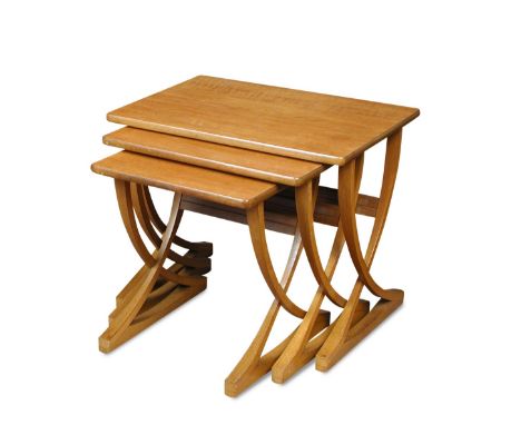 A nest of three Nathan teak tables, the rectangular tops on curving cross over end supports, original trade label to undersid