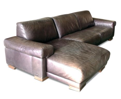 Natuzzi, Italy, a large modern black leather corner sofa, the two piece sofa raised on block feet 81 x 320 x 145cm (32 x 125 