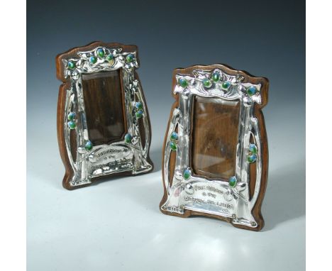 A matched pair of Art Nouveau silver and enamel photograph frames, by J. Aitkin & Son and John Thomas Heath & John Hartshorne