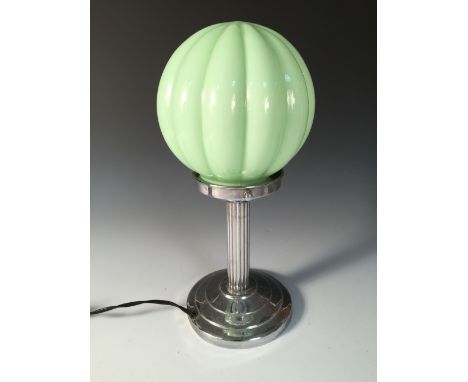 An Art Deco table lamp, the chromed fluted column to a stepped circular foot with pale green glass shade 32cm (12in)  