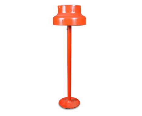 A 20th century red enamelled standard lamp, probably Swedish, the shaped shade above a cylindrical column and spreading circu