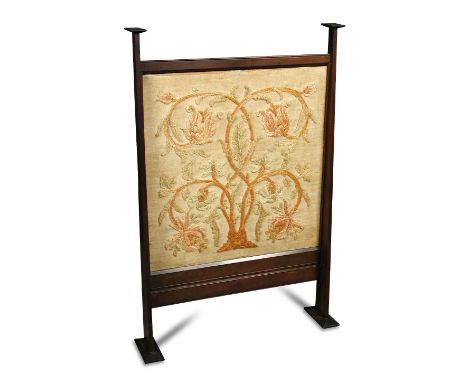 In the manner of C. F. A. Voysey (British, 1857-1941), a walnut framed firescreen, the tapering uprights with chamferred rect