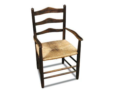 Attributed to Ernest Gimson, a rush seated child's ladder back chair, the ash frame with twin stretchers 65 x 39 x 34cm (25 x