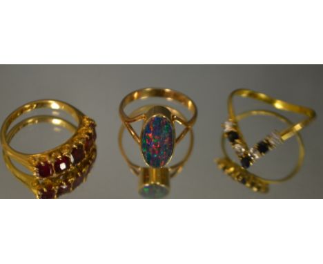 An 18ct gold five stone ruby ring; an 18ct gold diamond and gold opal cabochon ring, 9.5g gross (3)